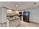 Modern basement kitchen featuring white cabinets and black appliances at 208 Hickory Rdg, Cumming, GA 30040