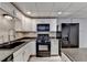 Basement kitchen with updated black appliances and white cabinets at 208 Hickory Rdg, Cumming, GA 30040