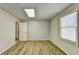 Spacious basement room with wood-look floors and neutral walls at 208 Hickory Rdg, Cumming, GA 30040