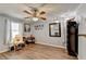 Bright bedroom with wood-look floors, ceiling fan, and window at 208 Hickory Rdg, Cumming, GA 30040