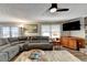 Living area featuring a sectional sofa and large TV at 208 Hickory Rdg, Cumming, GA 30040