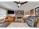 Cozy living room featuring a stone fireplace, hardwood floors, and comfortable seating at 208 Hickory Rdg, Cumming, GA 30040