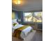 Bright bedroom with a large window, showcasing a gold throw and pillow, and neutral decor at 2479 Peachtree Ne Rd # 1103, Atlanta, GA 30305