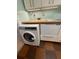 Modern laundry room with washer, dryer, and butcher block countertop at 2479 Peachtree Ne Rd # 1103, Atlanta, GA 30305