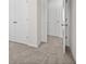 Bright bedroom with neutral carpeting and doors leading to closets and hallway at 3816 Thatcher Sw Dr, Marietta, GA 30008