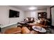 Finished basement recreation room with leather furniture and large TV at 4196 Roswell Rd Ne, Atlanta, GA 30342