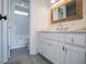 Clean bathroom with white vanity, marble countertop, and bathtub at 4196 Roswell Rd Ne, Atlanta, GA 30342