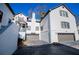 White two-story townhome with gray garage doors and landscaping at 4196 Roswell Rd Ne, Atlanta, GA 30342