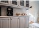 Kitchen with gray cabinets, marble backsplash and built in coffee bar at 4196 Roswell Rd Ne, Atlanta, GA 30342