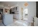 Modern kitchen with light gray cabinets, an island, and tile flooring at 4196 Roswell Rd Ne, Atlanta, GA 30342