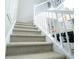 Modern staircase with neutral carpet and white railings at 4196 Roswell Rd Ne, Atlanta, GA 30342