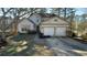 Two-story house with a two-car garage and a small yard at 5674 Wylmoor, Norcross, GA 30093