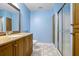 Basement bathroom with light blue walls, wood vanity, and shower at 745 Glengate Pl, Atlanta, GA 30328