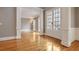 Hardwood floor entry with white French doors and wainscoting at 745 Glengate Pl, Atlanta, GA 30328