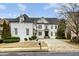 Stunning white brick home with a black roof, large windows, and a stone walkway at 745 Glengate Pl, Atlanta, GA 30328