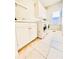 Bright laundry room with white cabinets and tile floor at 745 Glengate Pl, Atlanta, GA 30328