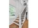 Elegant staircase with wrought iron railing and hardwood floors at 2049 Mcafee Rd, Decatur, GA 30032