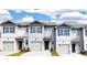 Gray townhouses with white accents and gray garage doors at 2102 Moss Hill Rd, Stone Mountain, GA 30088