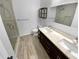 Modern bathroom with double vanity, frameless shower and wood-look tile floor at 1612 Alexandria Se Ct, Marietta, GA 30067
