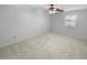 Bright bedroom with ceiling fan and neutral carpeting at 1612 Alexandria Se Ct, Marietta, GA 30067