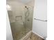 Large walk-in shower with glass enclosure and stone tile floor at 1612 Alexandria Se Ct, Marietta, GA 30067