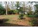 Large backyard space with mature trees and birdhouse at 2499 Little John Se Trl, Marietta, GA 30067