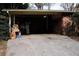 Brick carport with storage and cracked pavement at 2499 Little John Se Trl, Marietta, GA 30067
