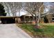 Brick ranch home with a long driveway and landscaping at 2499 Little John Se Trl, Marietta, GA 30067