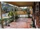 Brick front porch with tiled floor, wrought iron railings, and mature landscaping at 2499 Little John Se Trl, Marietta, GA 30067