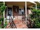 Covered porch with brick flooring, wrought iron railings, and plants at 2499 Little John Se Trl, Marietta, GA 30067