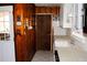 Kitchen features wood paneling, white cabinets, and a large sink at 2499 Little John Se Trl, Marietta, GA 30067