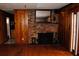 Living room boasts wood paneling, hardwood floors, and a brick fireplace at 2499 Little John Se Trl, Marietta, GA 30067