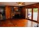 Living room with hardwood floors, brick fireplace, and access to deck at 2499 Little John Se Trl, Marietta, GA 30067