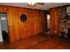 Living room features wood paneling, hardwood floors, and a ceiling fan at 2499 Little John Se Trl, Marietta, GA 30067