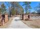Brick pillars and gate leading to a long driveway at 5024 Klondike Rd, Lithonia, GA 30038