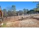 Spacious horse pasture with a metal gate and wooden fence at 5024 Klondike Rd, Lithonia, GA 30038