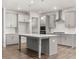 Open concept kitchen with gray island, stainless steel appliances, and hardwood floors at 42 Parkview Dr, Dallas, GA 30157