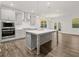 Modern kitchen with gray cabinetry, large island, stainless steel appliances, and hardwood floors at 42 Parkview Dr, Dallas, GA 30157