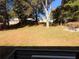 Large backyard with grass, trees, and a patio seating area at 1912 Canmont Ne Dr, Atlanta, GA 30319