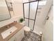 Modern bathroom with granite countertop, subway tile shower, and patterned floor at 1912 Canmont Ne Dr, Atlanta, GA 30319