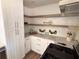 White kitchen with floating shelves, quartz countertops, and stainless steel appliances at 1912 Canmont Ne Dr, Atlanta, GA 30319
