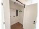 Convenient laundry closet with barn door, shelving, and hook for hanging clothes at 1912 Canmont Ne Dr, Atlanta, GA 30319