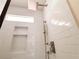 Modern shower with white subway tiles, niche shelves, and updated fixtures at 1912 Canmont Ne Dr, Atlanta, GA 30319