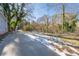 Large backyard with a concrete patio, partially covered in snow at 1156 Tucker Sw Pl, Atlanta, GA 30310