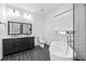 Elegant bathroom with double vanity, soaking tub, and walk-in shower at 1156 Tucker Sw Pl, Atlanta, GA 30310
