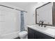 Updated bathroom with dark vanity, white countertop, and shower/tub combo at 1156 Tucker Sw Pl, Atlanta, GA 30310