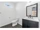 Updated half bathroom with dark vanity and white countertop at 1156 Tucker Sw Pl, Atlanta, GA 30310