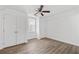 Bright bedroom with double doors, ceiling fan, and wood-look flooring at 1156 Tucker Sw Pl, Atlanta, GA 30310