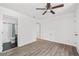Bedroom with ceiling fan, access to bathroom, and wood-look flooring at 1156 Tucker Sw Pl, Atlanta, GA 30310
