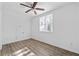 Bright bedroom with ceiling fan, window, and wood-look flooring at 1156 Tucker Sw Pl, Atlanta, GA 30310